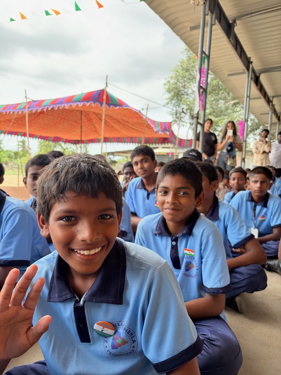 School students seated at a Street Cause VNR camp, one waving at the camera